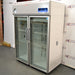 Right three-quarter angle product view of a Thermo Scientific TSX5005CA high-performance laboratory refrigerator, highlighting its right exterior side panel, dual glass doors, handles, and top-mounted digital interface