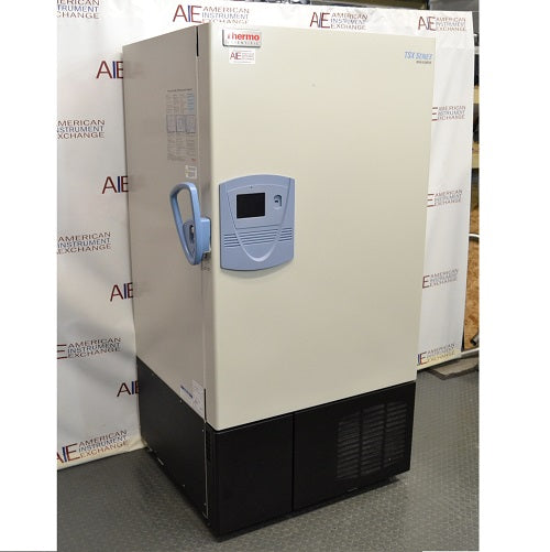 Left angled perspective view of a Thermo Scientific TSX600D ultra-low temperature freezer showcasing its door handle, digital control console, and side panel warning labels