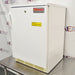 Thermo Scientific undercounter laboratory refrigerator ka right angle view, jisme white exterior body ka right side, front door, key lock, aur ventilation grille stainless steel table par rakhe hue saaf nazar aa rahe hain.   