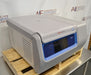 Side angled perspective view of a Thermo Sorvall X1R Pro refrigerated centrifuge resting on a wooden pallet showcasing its side ventilation panels, control console, and main housing