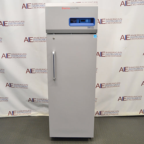 Front eye-level view of a Thermo TSX1230FA high-performance -30C freezer, featuring a light grey exterior body, a tall locking solid door with an ergonomic vertical handle, and a top-mounted control console with a digital display and Thermo Scientific branding