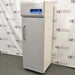 Right angled perspective view of a Thermo TSX1230FA high-performance -30C freezer, featuring its light grey cabinet housing, tall solid locking door with a vertical handle, and top control console with digital display