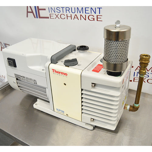 Front product view of a Thermo Scientific VLP120 deep vacuum oil pump, featuring a white motor housing, central control block, vertical exhaust filter canister, and brass inlet fitting on a stainless steel lab bench
