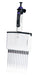 A front view of an upright BRANDTECH Transferpette S 12-channel adjustable pipette featuring a white body with green accents, a digital volume display window, top plunger button, and twelve clear pipette tips attached at the base.