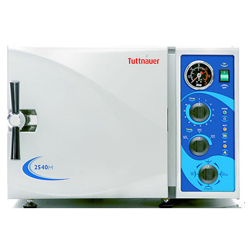 Front angle product view of a Tuttnauer 2540MK 23L Manual KwiKlave autoclave, featuring its light grey body housing, front door with a chrome locking handle, and a right-hand control panel with mechanical dials, pressure gauge, and power switch