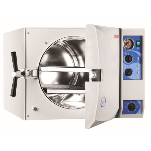 Front angle product view of a Tuttnauer 3870M 85L large-capacity manual autoclave with its front door open, showing the large cylindrical stainless steel inner chamber, internal tray rails, and right-hand control panel