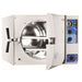 Front angle product view of a Tuttnauer 3870M 85L large-capacity manual autoclave with its front door open, showing the large cylindrical stainless steel inner chamber, internal tray rails, and right-hand control panel