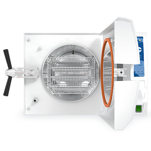 Front angle product view of a Tuttnauer EA Series 2540EKA 23L tabletop autoclave with its front door swung open, showcasing the orange rubber door gasket, cylindrical stainless steel chamber, and internal wire instrument racks
