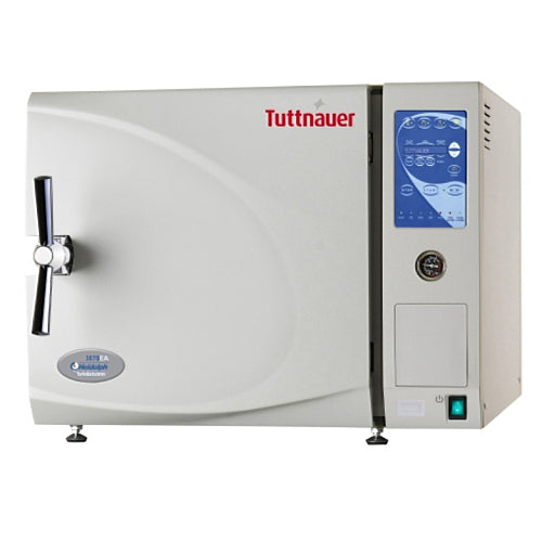 Front angle product view of a Tuttnauer EA Series 3870EA 85L tabletop autoclave, featuring its light grey body housing, front-loading door with a polished metal locking handle, digital control panel interface, and integrated pressure gauge