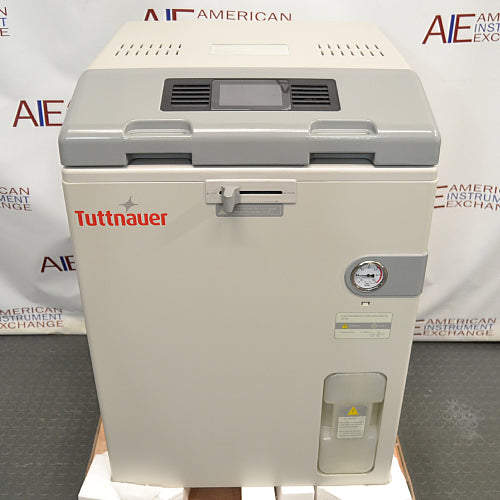 Front product view of a Tuttnauer LabSci 85LV vertical autoclave, featuring its beige cabinet enclosure, grey top control console with an integrated display, pressure gauge, safety latch mechanism, and bottom water reservoir bottle