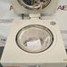 Top angle product view of a Tuttnauer LabSci 85LV vertical autoclave with its top lid open, showcasing the open internal sterilization chamber lined with protective bubble wrap packaging and documentation