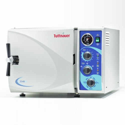 Front angle product view of a Tuttnauer MK-Series 2340MK 19L Manual KwiKlave autoclave, featuring its light grey housing, front door with a chrome locking handle, and a right-hand control panel featuring mechanical dials, pressure gauge, and power switch