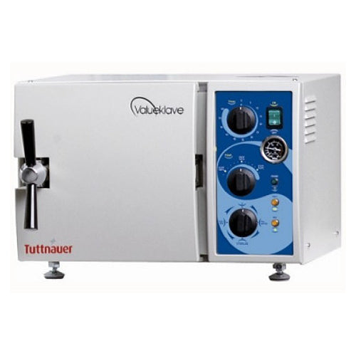Front angle product view of a Tuttnauer Valueklave 1730 manual tabletop autoclave, featuring its compact light grey body housing, front door with a chrome locking handle, and a right-hand blue control panel with mechanical knobs and pressure gauge