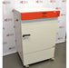 A white, upright Binder KB240 refrigerated incubator with a distinctive orange control panel, positioned in front of an American Instrument Exchange backdrop.