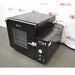 Angled side view of USA Lab USA-VO-34-UL vacuum oven showing black main housing, glass door, control panel with gauge, and attached rear vacuum valve connection