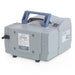 Front three-quarter product view of a Vacuubrand ME 4C NT chemistry diaphragm vacuum pump, featuring its grey housing, top blue carrying handle, specification plate, and inlet port