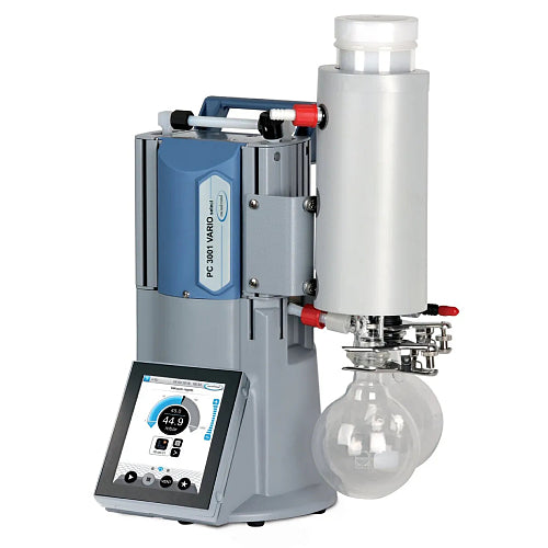 Front three-quarter product view of a Vacuubrand PC 3001 VARIO Select TE chemistry pumping unit, highlighting its vertical grey housing, integrated touchscreen controller, emission condenser, and dual glass collection flasks