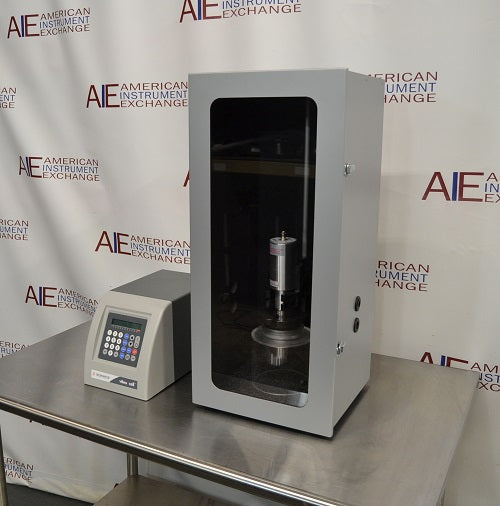 Left angled perspective view of Sonics Vibra-Cell VCX 500 ultrasonic processor control unit on stainless steel table next to sound-abating enclosure containing converter and probe assembly