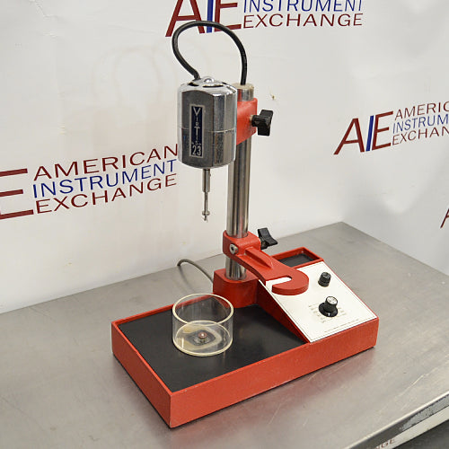 Right three-quarter angle product view of a Virtis Model 23 micro homogenizer, showing its red and chrome motor drive on a vertical stand, integrated control panel, base platform, and glass vessel on a stainless steel lab bench