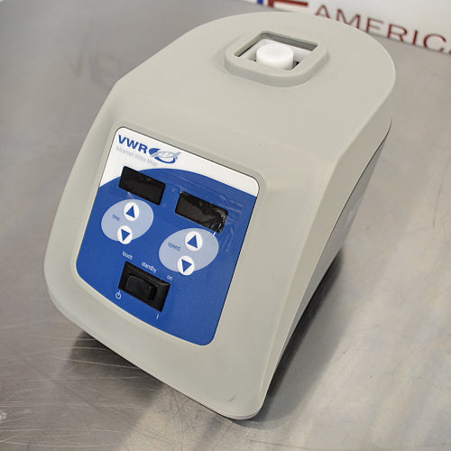 Left three-quarter angle product view of a VWR advanced heavy-duty vortex mixer, showing the side profile, top mixing cup head, and angled digital control interface on a stainless steel work surface