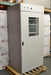 Front angled perspective view of a VWR Model 1925 reach-in incubator mounted on a wooden pallet, featuring a full-height solid door with a central viewing window, a top-mounted control panel, and internal wire shelving visible through the glass