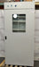 Front eye-level view of a VWR Model 1925 reach-in incubator resting on a wooden pallet, featuring a tall solid door with a central glass viewing window, top-mounted digital and analog control panel, and internal wire shelving