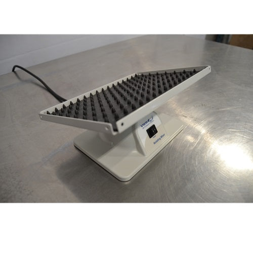 Angled high-angle view of a VWR Nutating Mixer showing the tilted top platform with a dimpled rubber mat and white base