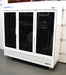 Front eye-level view of a VWR triple glass door laboratory refrigerator on locking casters, featuring a white cabinet body, three black-tinted glass doors with upright white handles, upper VWR branding, and a louvered bottom grille