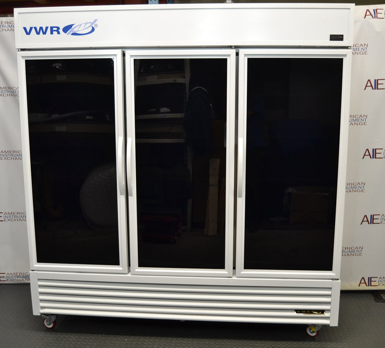 Straight-on front view of a VWR triple glass door laboratory refrigerator on caster wheels, featuring a white cabinet body, three tinted glass doors with vertical handles, top blue branding, and a louvered bottom grille