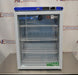 Front eye-level view of a VWR undercounter glass door laboratory refrigerator resting on a stainless steel surface featuring wire shelving and a top digital control panel