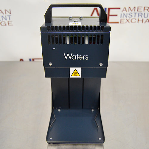 Front product view of a Waters Combi Thermo Sealer plate sealing machine, highlighting its dark blue housing, top carrying handle, ventilation slots, hot surface warning label, and base platform on a lab bench