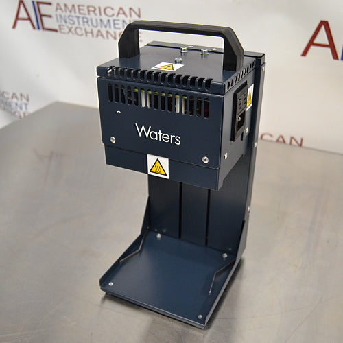 Right three-quarter angle product view of a Waters Combi Thermo Sealer plate sealing machine, highlighting the top carrying handle, power inlet module on the side panel, hot surface warning labels, and base platform on a lab bench