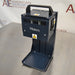 Right three-quarter angle product view of a Waters Combi Thermo Sealer plate sealing machine, highlighting the top carrying handle, power inlet module on the side panel, hot surface warning labels, and base platform on a lab bench