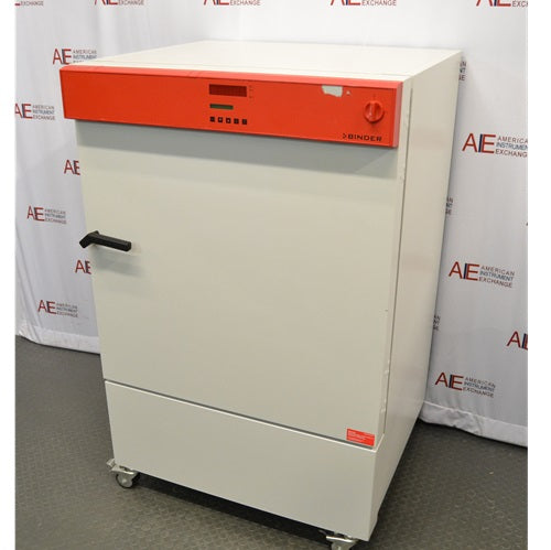 A slightly different angle of the white Binder KB240 refrigerated incubator featuring its orange control panel, positioned in front of an American Instrument Exchange backdrop.