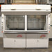 A white Fisher Hamilton 8' Chemical Fume Hood with flammable storage base cabinets, featuring a split vertical-rising sash, a work surface, and various fixtures such as monkey bars and external outlets.