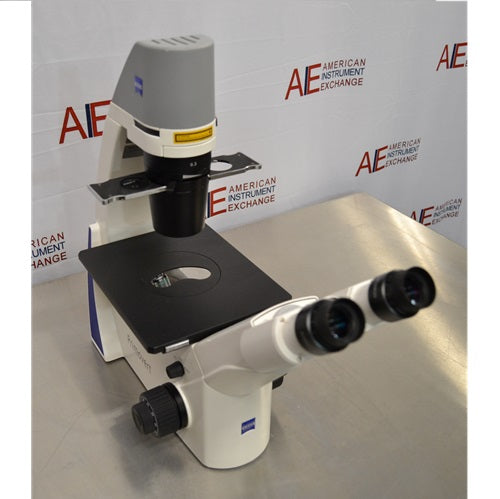 Right perspective view of Zeiss Primovert inverted microscope showing binocular tube, stage plate, coarse and fine focus controls, and illumination column