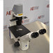 Right perspective view of Zeiss Primovert inverted microscope showing binocular tube, stage plate, coarse and fine focus controls, and illumination column