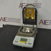 Angled front view of Ohaus MB35 moisture analyzer balance with open heating hood showing interior gold chamber