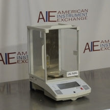 Angled view of Ohaus Explorer E10640 analytical balance with glass draft shield enclosure on metallic counter