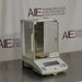 Angled view of Ohaus Explorer E10640 analytical balance with glass draft shield enclosure on metallic counter