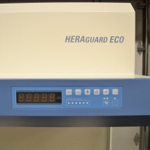 A close-up view of the digital control panel and brand logo on a Thermo Heraguard ECO 1.8 laminar flow clean bench, featuring an LED display screen and operational control buttons.