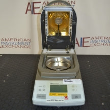 Front view of Ohaus MB35 moisture analyzer balance with heating cover open showing interior heating chamber and sample pan