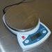 High-angle side view of powered-on Ohaus CS 200 compact digital scale displaying zero