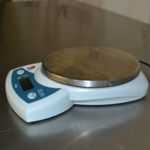 Low-angle view of Ohaus CS 200 compact digital scale on metallic counter