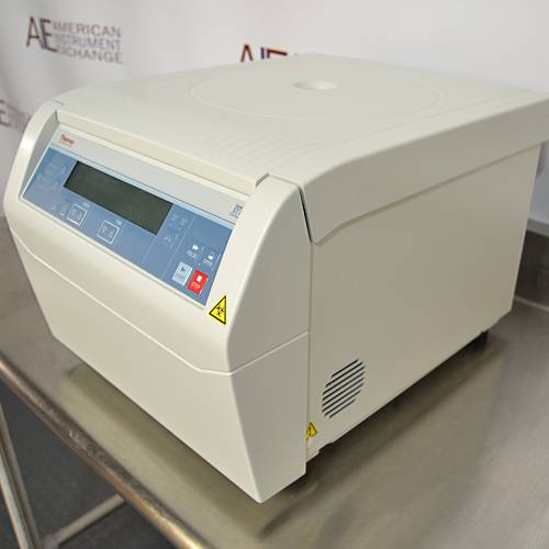Right angled perspective view of a Thermo Scientific Sorvall ST8 benchtop centrifuge resting on a stainless steel surface, featuring its light grey housing, closed lid, side cooling vent, and digital control panel